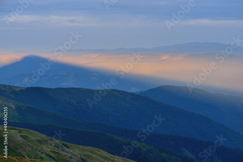 Summer landscape panorama  shadow of mountain at sunrise