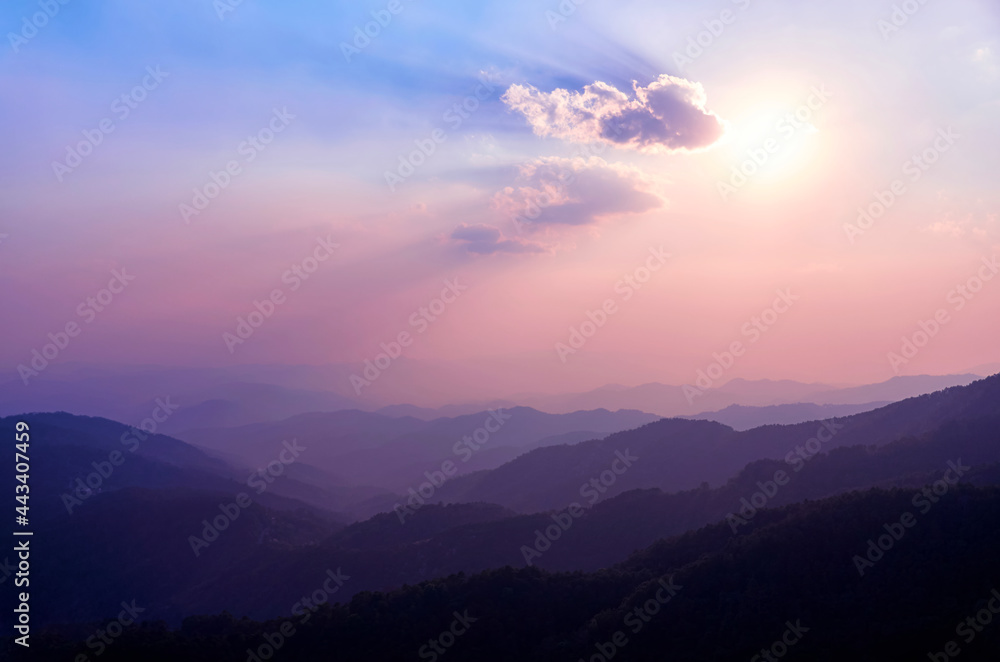 Sunset in the mountains of Northern Thailand. Mountains in the haze. Rainforest in the foreground. Doi Tung Mountain. Chiang Rai province. Thailand. Thai highlands