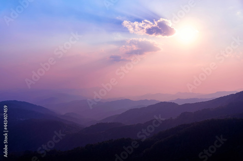Sunset in the mountains of Northern Thailand. Mountains in the haze. Rainforest in the foreground. Doi Tung Mountain. Chiang Rai province. Thailand. Thai highlands