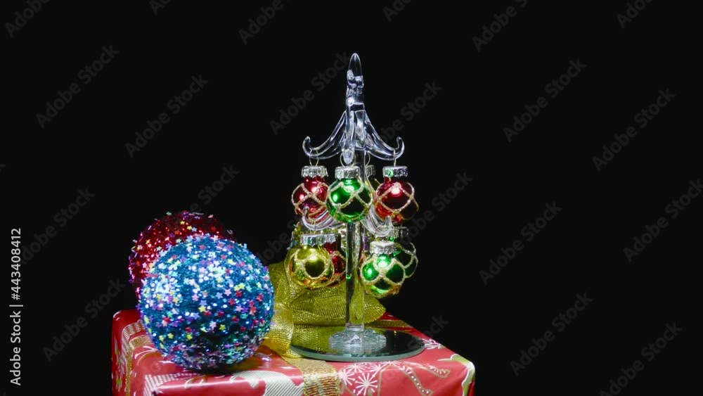 Video postcard on a rotating gift a small Christmas tree stands surrounded by Christmas decorations Video postcard on a rotating gift a small Christmas tree stands surrounded by Christmas decorations