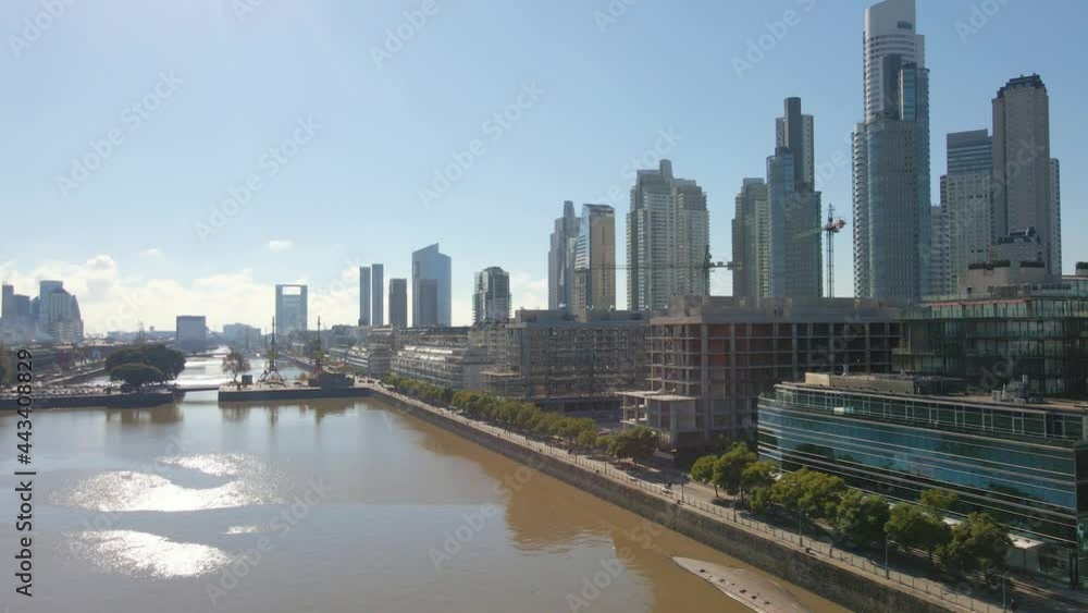Aerial flying over a wateway revealing some skycrapers at right in Buenos Aires Aerial flying over a wateway revealing some skycrapers at right in Buenos Aires