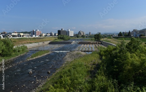 The peaceful Toyohira river from the Minami Hiragishi bridge in Sapporo Japan