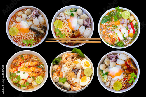 Top view noodle soups or Tom Yum is delicious , hot and spicy fast food on black background. 
