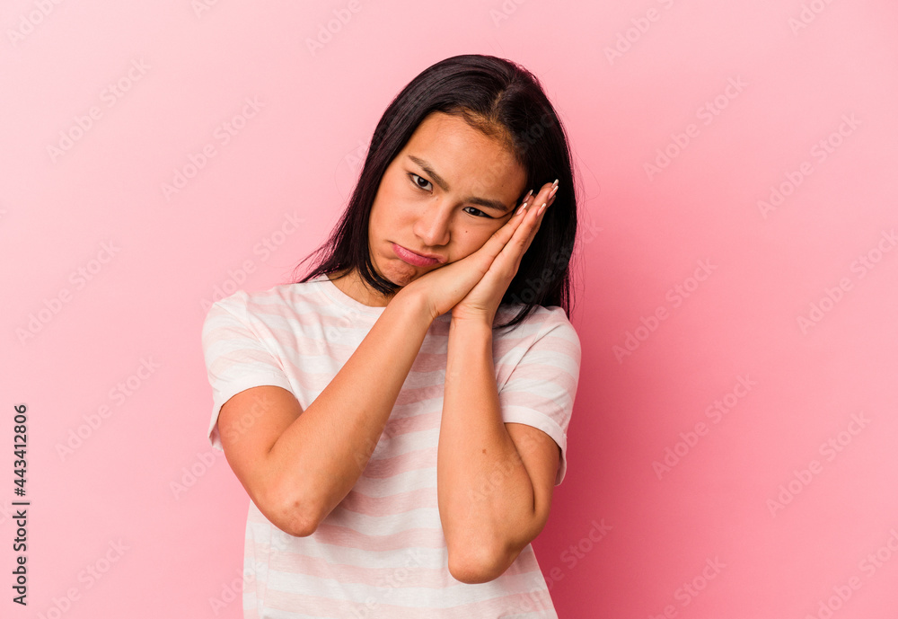 Young Venezuelan woman isolated on pink background yawning showing a tired gesture covering mouth with hand. Young Venezuelan woman isolated on pink background yawning showing a tired gesture covering mouth with hand.