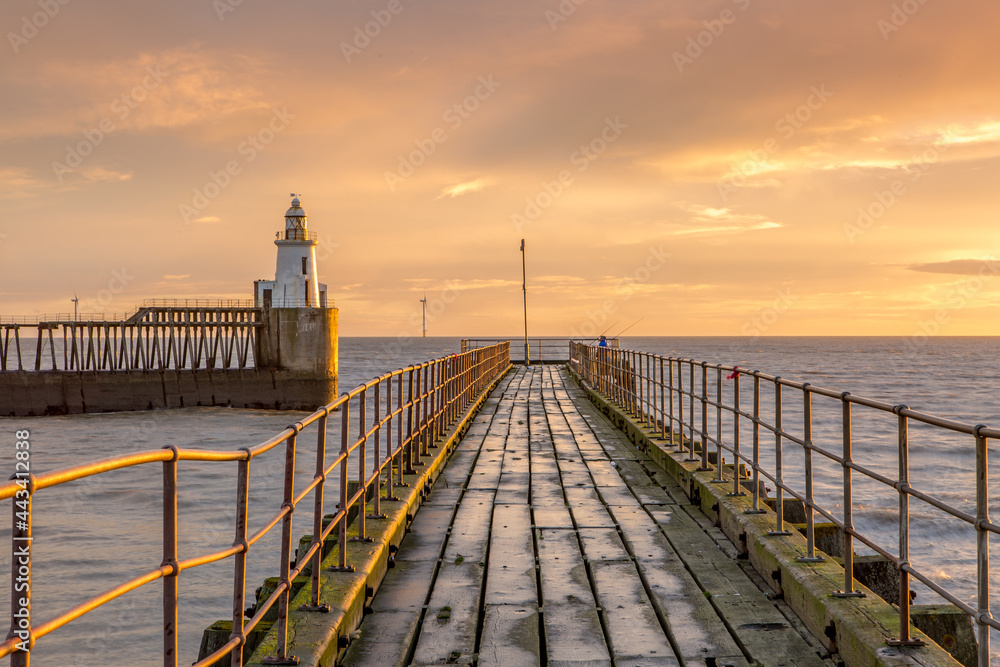 A glorious morning at Blyth beach, with a beautiful sunrise over the old wooden Pier stretching out to the North Sea A glorious morning at Blyth beach, with a beautiful sunrise over the old wooden Pier stretching out to the North Sea