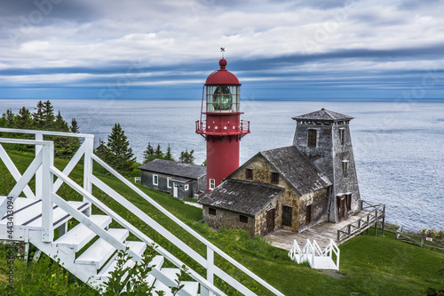 View on the beautiful Pointe a la Renommée Lighthouse covered with shingles, one of the most famous lighthouse of Gaspesie, in Quebec (Canada)
 photo