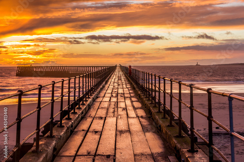 A glorious morning at Blyth beach  with a beautiful sunrise over the old wooden Pier stretching out to the North Sea