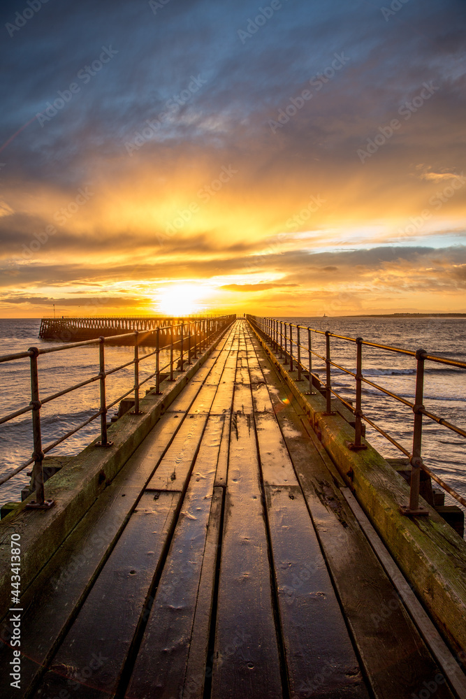 A glorious morning at Blyth beach, with a beautiful sunrise over the old wooden Pier stretching out to the North Sea