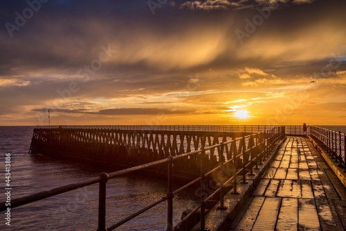 A glorious morning at Blyth beach  with a beautiful sunrise over the old wooden Pier stretching out to the North Sea