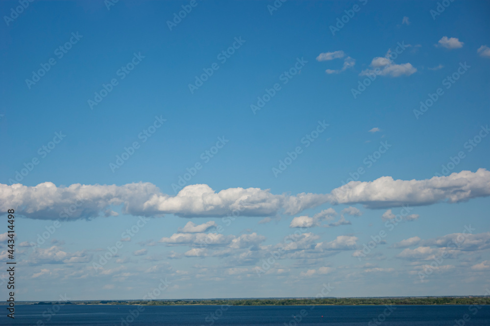 Blue sky with lots of thick clouds. Sky background.