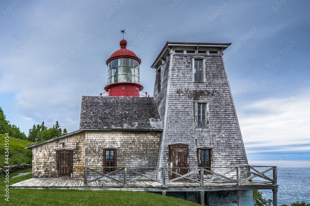 View on the beautiful Pointe a la Renommée Lighthouse covered with shingles, one of the most famous lighthouse of Gaspesie, in Quebec (Canada)
