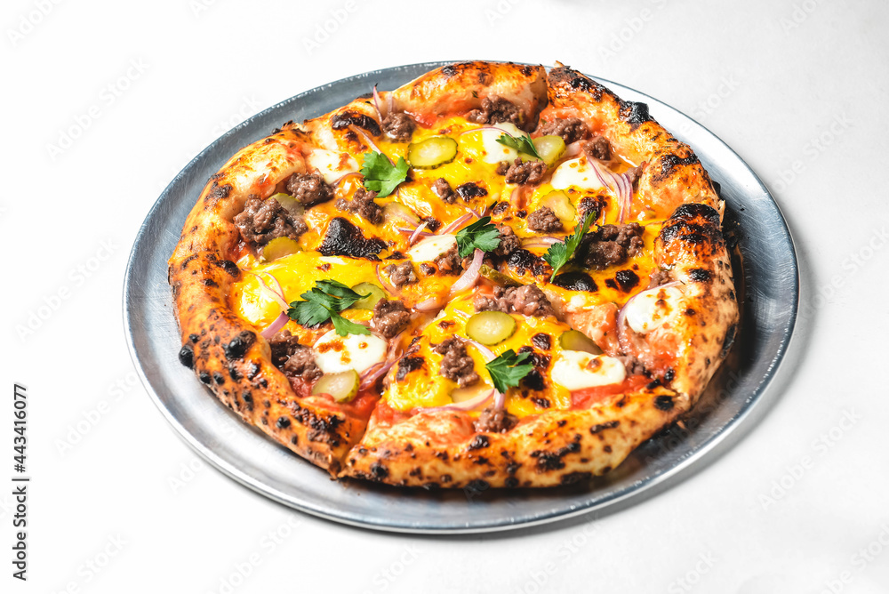 Whole cheese and minced meat pizza over white background. Whole cheese and minced meat pizza over white background.