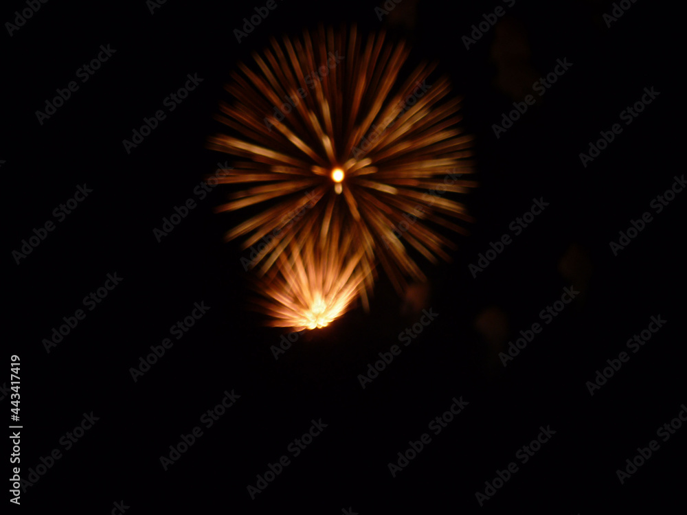 Festive fireworks in the black night sky blurred no focus