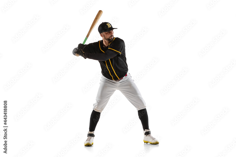 Baseball player, pitcher in a black white sports uniform practicing isolated on a white studio background. Baseball player, pitcher in a black white sports uniform practicing isolated on a white studio background.