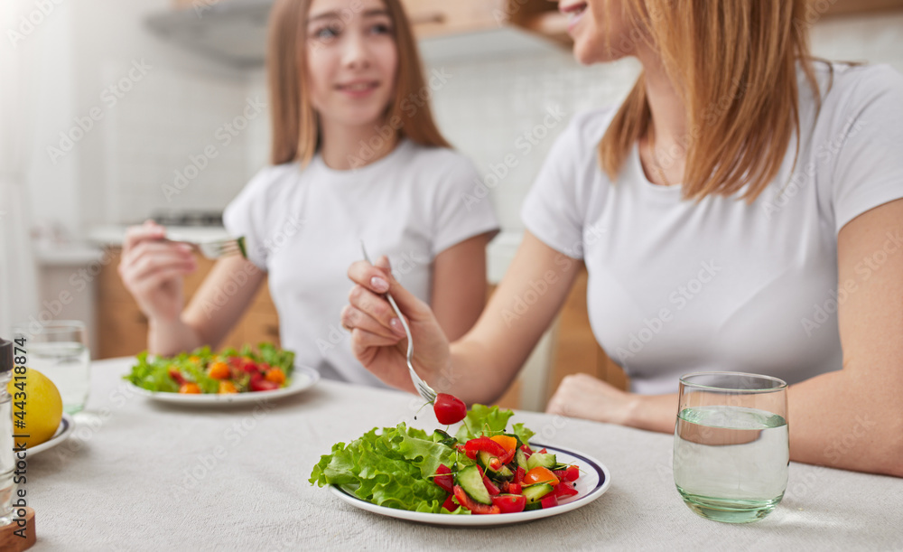 Mother and daughter having healthy breakfast together