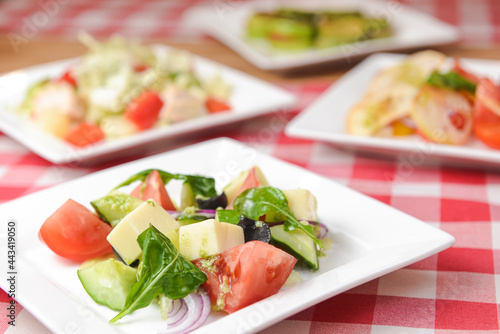 Greek salad with cheese, juicy tomatoes, red pepper, red onion, cucumber and lettuce.