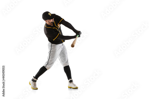 Baseball player, pitcher in a black white sports uniform practicing isolated on a white studio background.