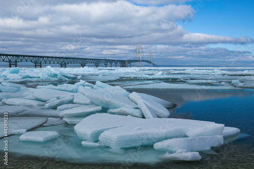Winter landscape of blue ice shards and the Mackinac Bridge, Straits of Mackinac, Lake Michigan, Michigan, USA photo