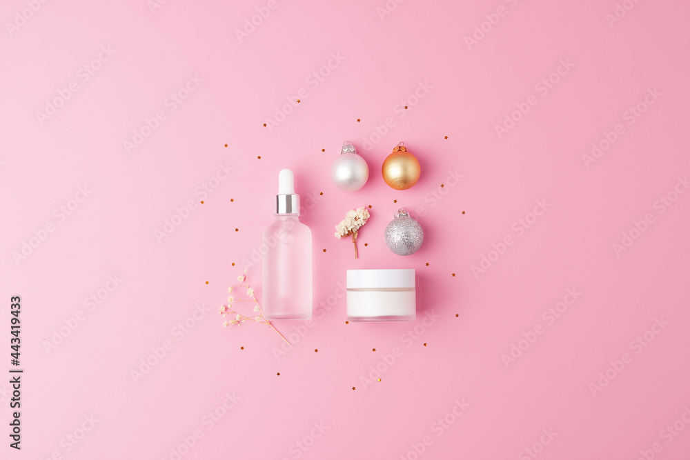 Christmas cosmetic product display. Skin care products on pink background. Flat lay, copy space Christmas cosmetic product display. Skin care products on pink background. Flat lay, copy space