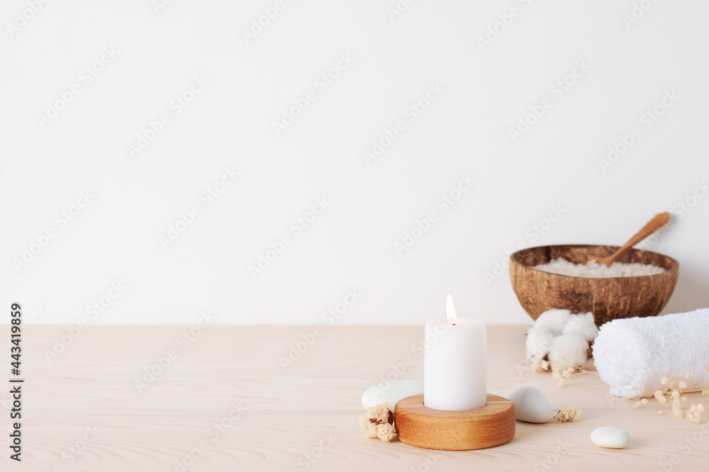 Spa treatment with candles, towel and flowers on white background. Close up, copy space Spa treatment with candles, towel and flowers on white background. Close up, copy space