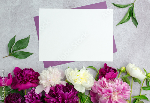 Fototapeta Naklejka Na Ścianę i Meble -  Blank paper and peony flowers. Blank for a greeting card or invitation. Flower background