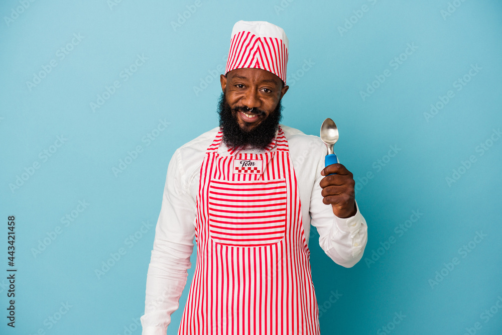 African american ice cream maker man holding an ice cream scoop isolated on  blue background happy, smiling and cheerful. Stock Photo | Adobe Stock