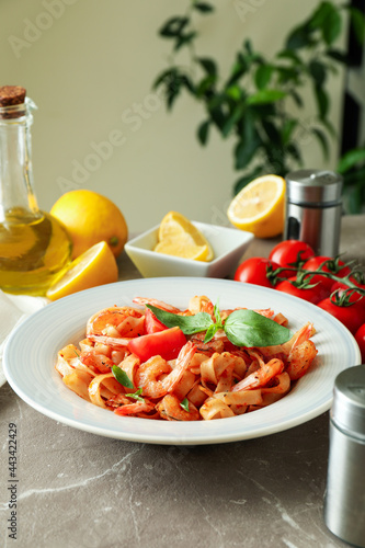 Concept of cooking shrimp pasta on gray textured table