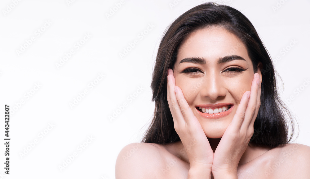 Smiling young woman isolated on white background. Asian happy girl touching her face with clean fresh skin while looking at camera. Healthy skin care concept. Smiling young woman isolated on white background. Asian happy girl touching her face with clean fresh skin while looking at camera. Healthy skin care concept.