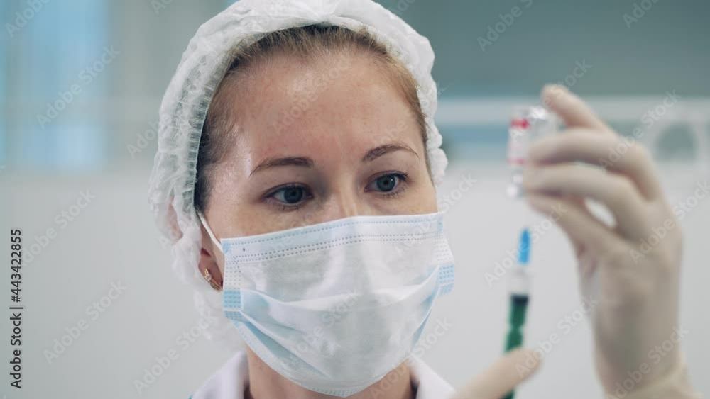 Medical worker is filling a syringe with vaccine Medical worker is filling a syringe with vaccine