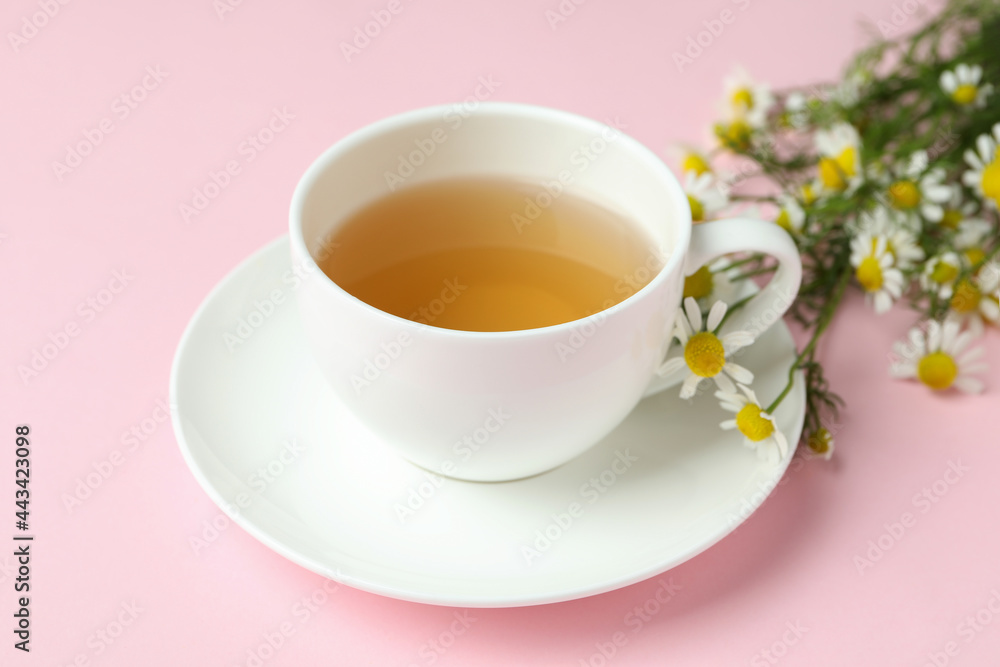 Cup of chamomile tea on pink background Cup of chamomile tea on pink background