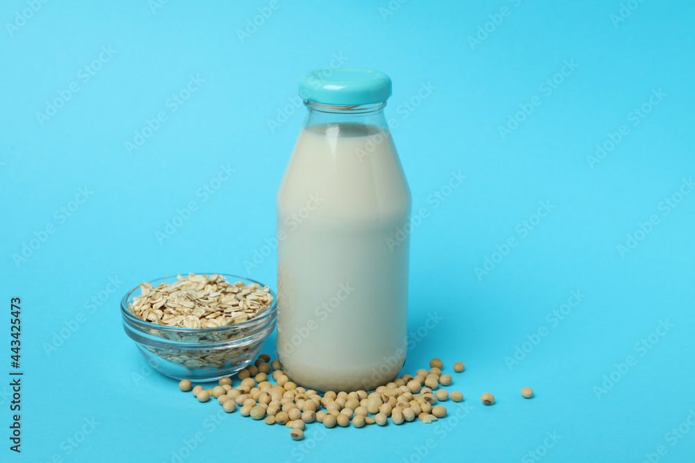 Concept of vegan milk on blue background Concept of vegan milk on blue background