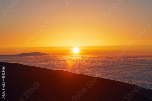 Sun above clouds. Mountain landscape at golden sunset. Tenerife  Canary Islands  Spain.