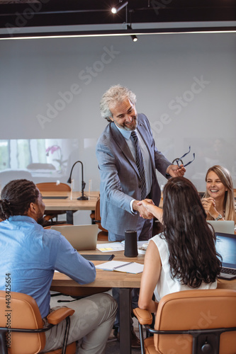 Cropped shot of two businesspeople shaking hands during a meeting in the boardroom. Business people shaking hands after meeting. Shot of two businesspeople shaking hands in a meeting