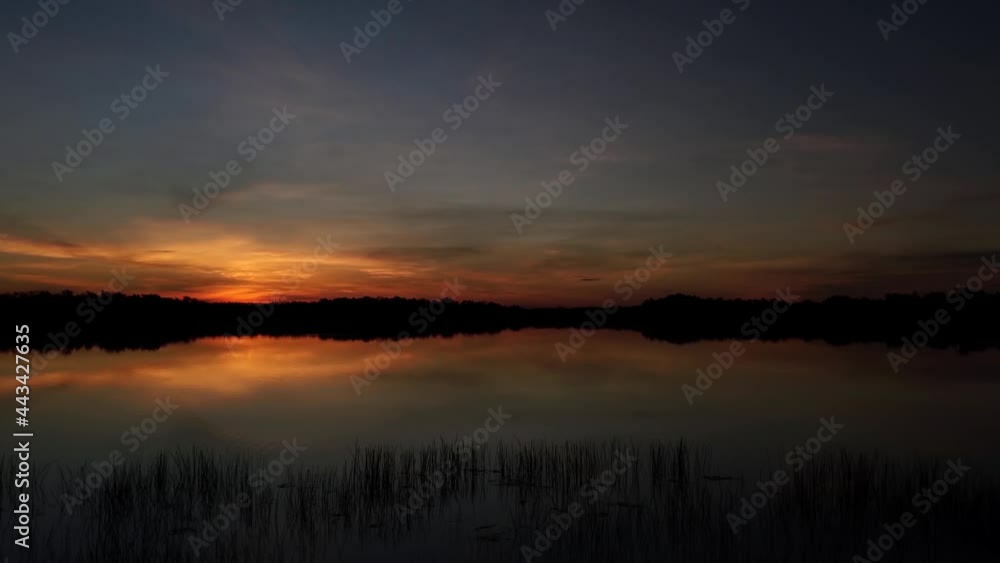 Timelapse of colorful sunrise over Nine Mile Pond in Everglades National Park on calm summer morning 4K. Timelapse of colorful sunrise over Nine Mile Pond in Everglades National Park on calm summer morning 4K.