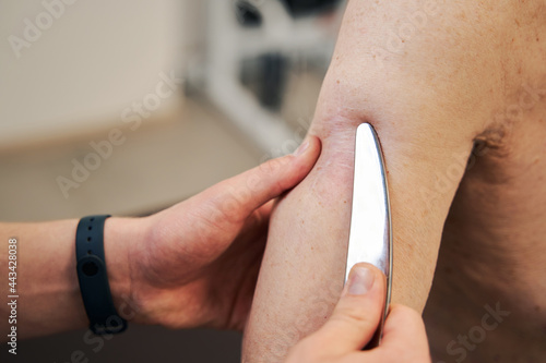 Billede på lærred Gua sha scraping tool pressed to aged male skin