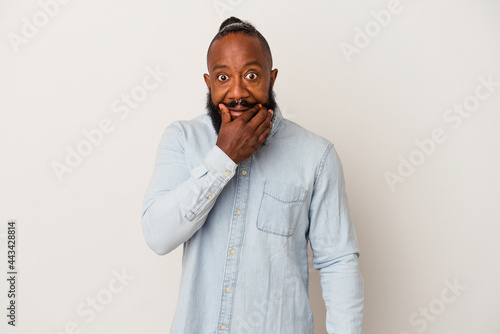 African american man with beard isolated on pink background doubting between two options.