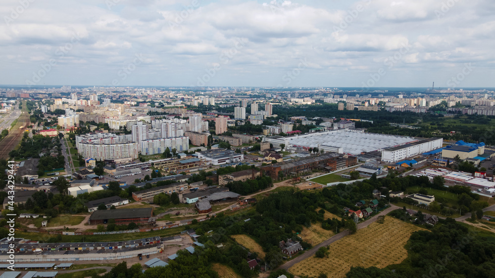 City landscape. High-rise buildings and an industrial area next door. Aerial photography.