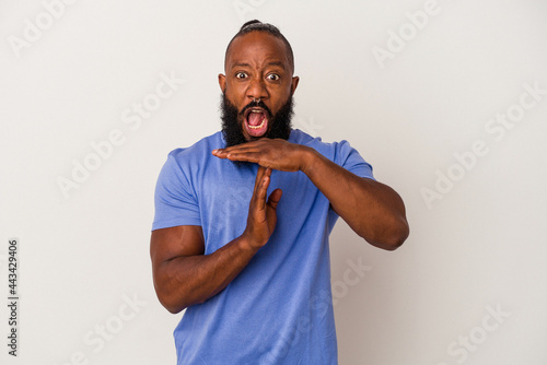 African american man with beard isolated on pink background showing a timeout gesture.