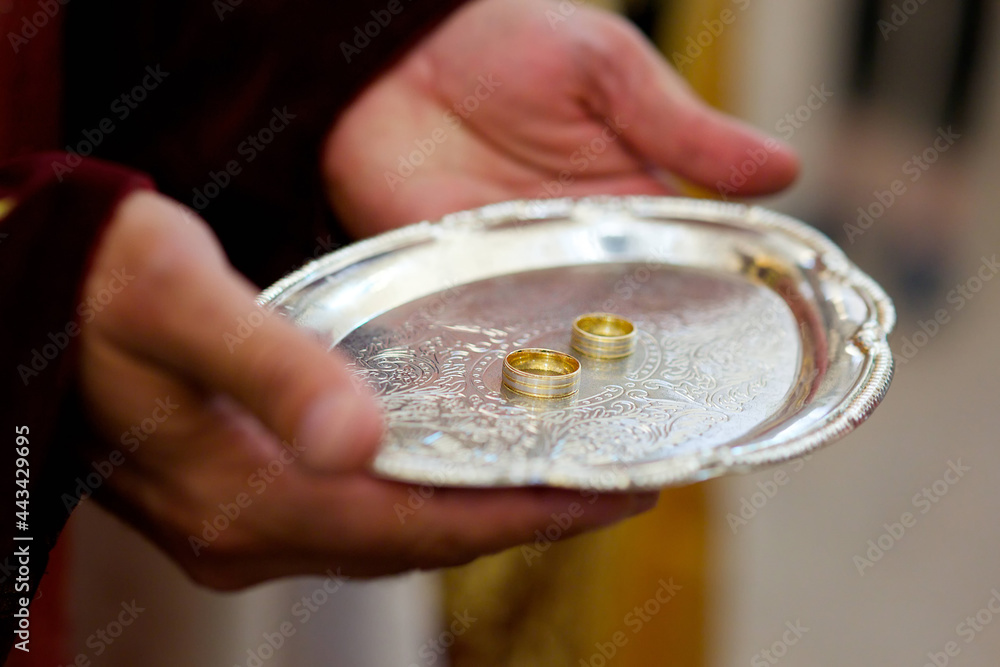 A Christian priest holds in his hands a wedding ring.