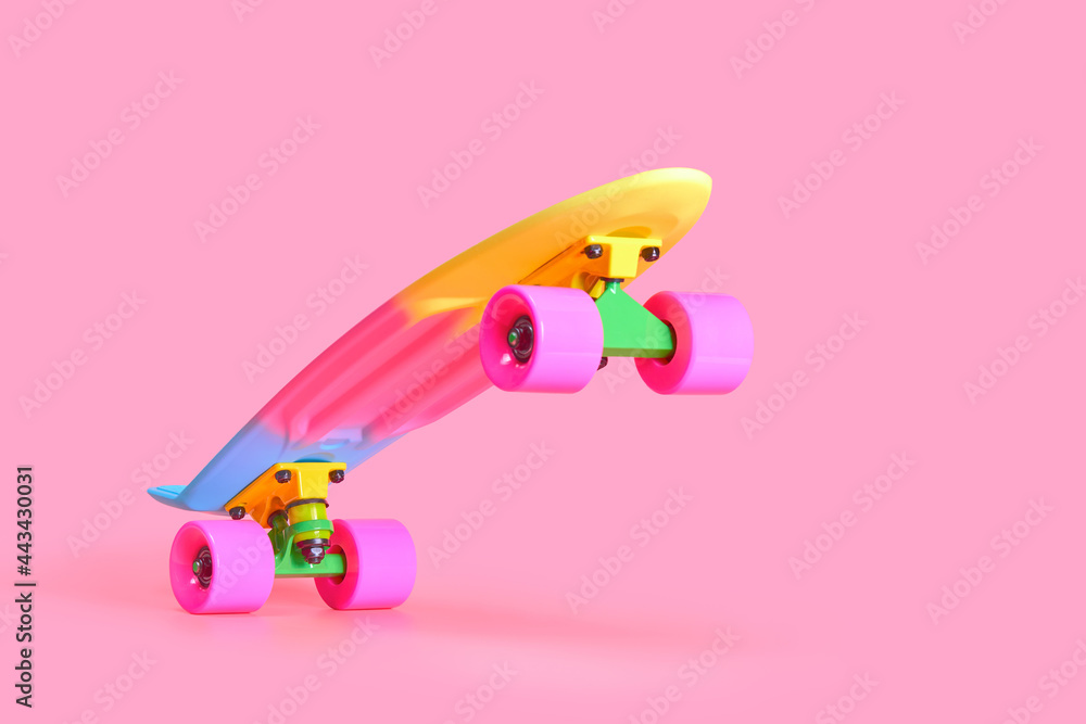Pastel neon rainbow colored Penny board skateboard standing on two wheels  isolated on solid soft pink background. Plastic mini cruiser Youth  minimalistic Sport inspired summer fun concept. Copy space. Stock Photo
