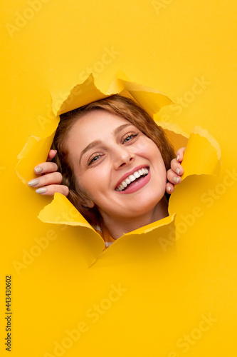 Happy female tearing paper and smiling © kegfire