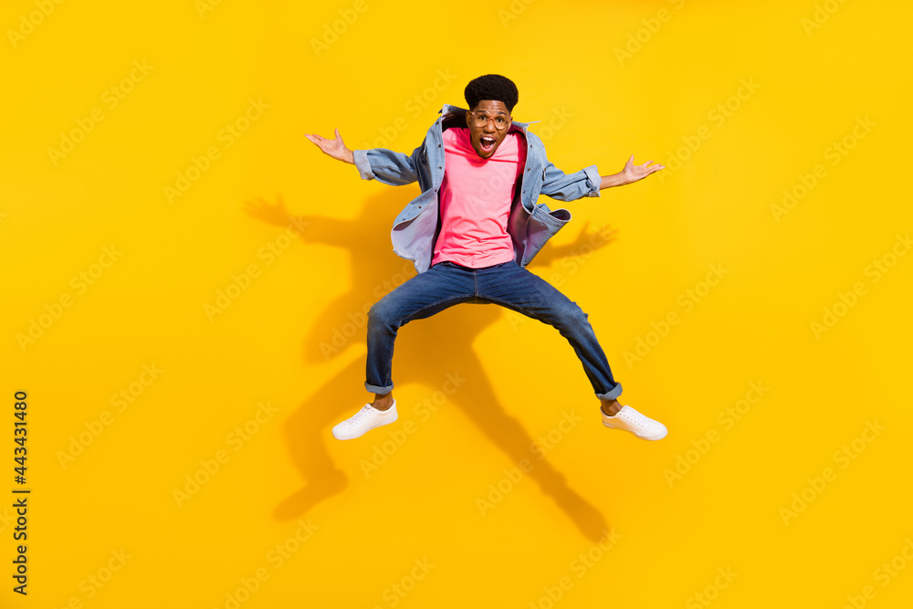 Full body photo of afro american young funky man jump up wear glasses isolated on yellow color background