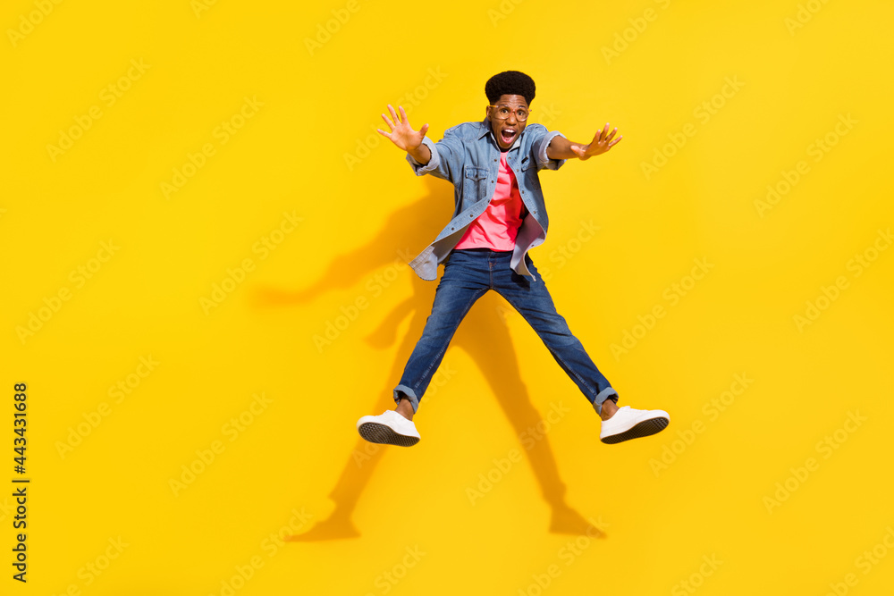 Fototapeta premium Full length photo of happy afro american young man jump up crazy mood isolated on yellow color background