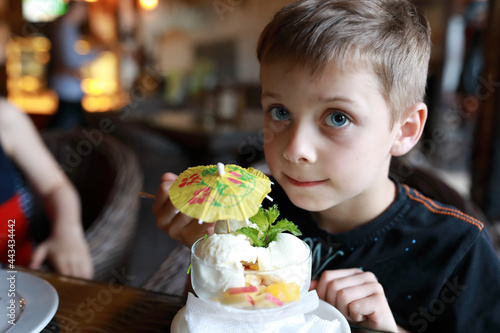 Child eating ice cream in restaurant