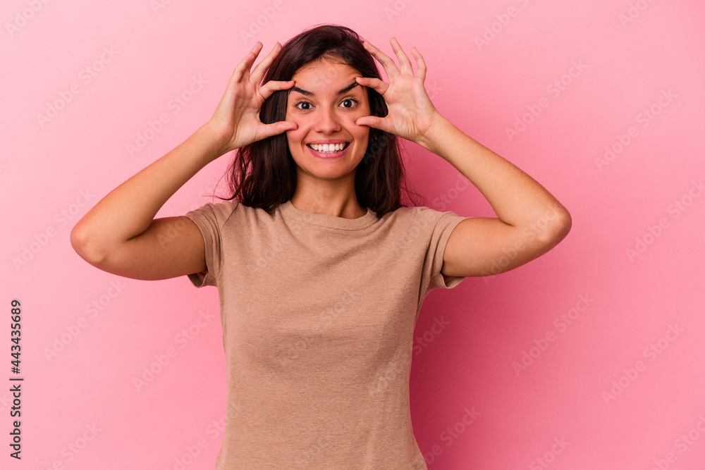 Young caucasian woman isolated on pink background keeping eyes opened to find a success opportunity. Young caucasian woman isolated on pink background keeping eyes opened to find a success opportunity.