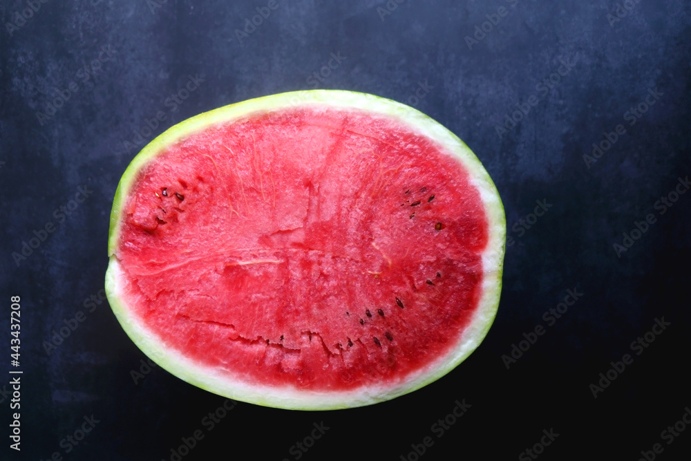Half of watermelon on dark background. Top view. Half of watermelon on dark background. Top view.