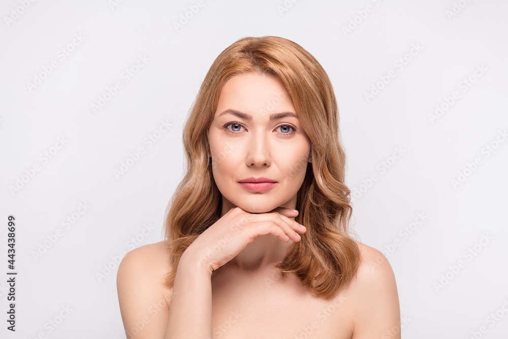 Fototapeta premium Photo portrait woman with blonde hair touching chin serious calm isolated white color background