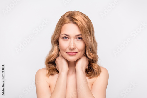 Photo portrait woman with naked shoulders touching neck doing skin treatment isolated white color background