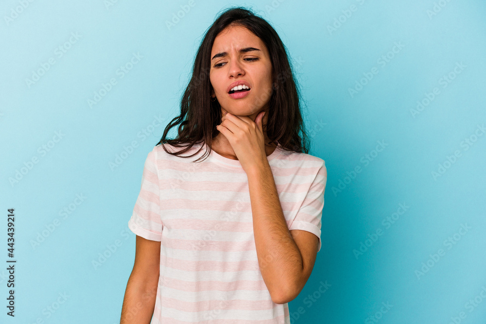 Young caucasian woman isolated on blue background touching back of head, thinking and making a choice. Young caucasian woman isolated on blue background touching back of head, thinking and making a choice.