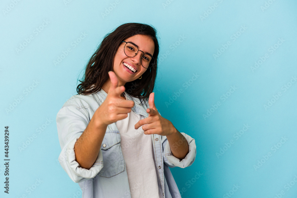 Young caucasian woman isolated on blue background cheerful smiles pointing to front. Young caucasian woman isolated on blue background cheerful smiles pointing to front.